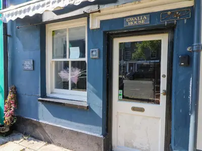 a blue building with a door and a window at The Little Laura Ashley House in Machynlleth