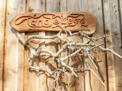 a wooden heart made out of branches on a wooden wall at Tanglewood Shepherds Hut in Welshpool