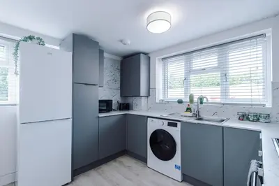 a kitchen with a washer and dryer in it at Double the Comfort - 2 Hansas Luxury & Spacious Townhouses by Parydise Properties - Ideal for Business or Family in Harlescott