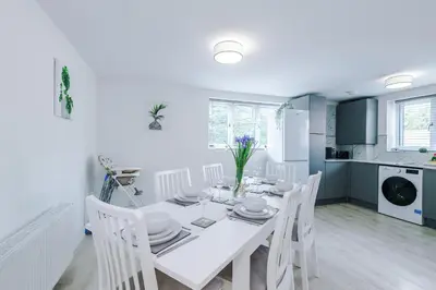 a white dining room with a white table and chairs at Double the Comfort - 2 Hansas Luxury & Spacious Townhouses by Parydise Properties - Ideal for Business or Family in Harlescott