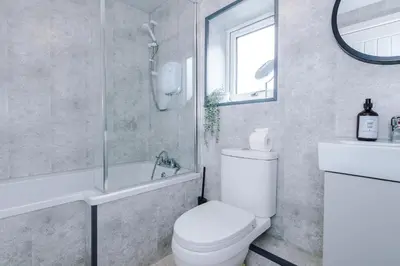 a bathroom with a toilet and a shower and a sink at Double the Comfort - 2 Hansas Luxury & Spacious Townhouses by Parydise Properties - Ideal for Business or Family in Harlescott