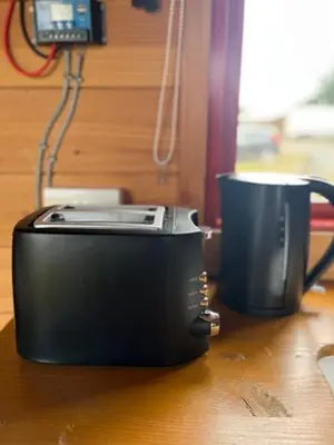 a printer sitting on a table next to a mug at Black Bridge Cabin in Lyonshall