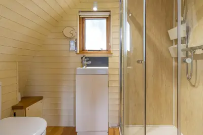 a bathroom with a sink and a shower at Pod1 - Powys River Pods - Pet Friendly Glamping Pod Builth Wells Powys Wales in Garth