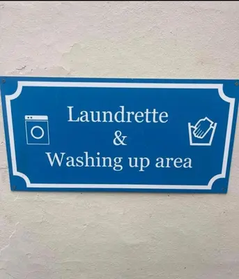 a blue sign that reads laundrite and washing up area at Pod1 - Powys River Pods - Pet Friendly Glamping Pod Builth Wells Powys Wales in Garth