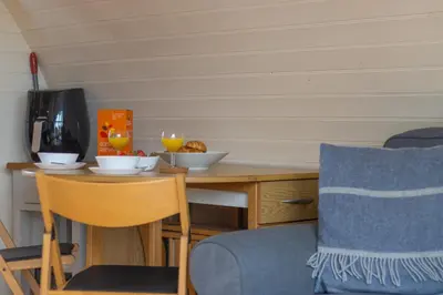 a small table with two bowls of food on it at Pod1 - Powys River Pods - Pet Friendly Glamping Pod Builth Wells Powys Wales in Garth