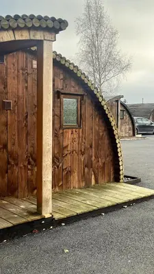 a wooden cabin with a roof with a window at Pod3 - Powys River Pods - Pet Friendly Glamping Pod Builth Wells Powys Wales in Garth