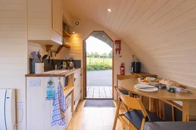 a small kitchen with a table and a counter at Pod3 - Powys River Pods - Pet Friendly Glamping Pod Builth Wells Powys Wales in Garth