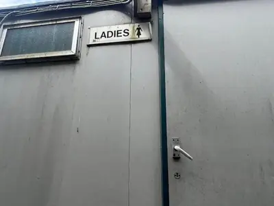 a sign on the side of a building that says ladies at Tinkers Horn Cabin in Kington