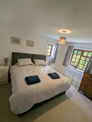 a bedroom with a bed with two towels on it at Breidden Annexe in Four Crosses