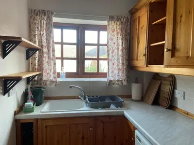 a kitchen with a sink and a window at Breidden Annexe in Four Crosses
