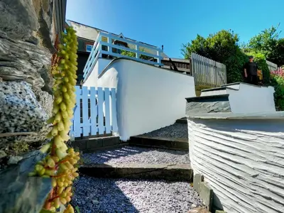 a stairway with a train on top of a building at Mousehole in Aberdyfi Charming Seaside Fisherman's Cottage in Aberdyfi