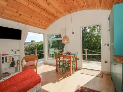 a living room with a desk and a table at Squirrel's Drey in Bucknell