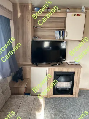 a living room with a tv and a fireplace at Browns 137 Snowdon Summit 099 in Barmouth