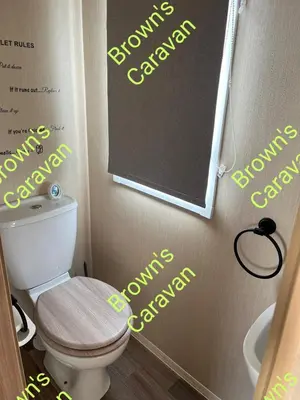 a bathroom with a toilet with yellow writing on the wall at Browns 137 Snowdon Summit 099 in Barmouth