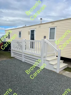 a mobile home with a porch and a white railing at Browns 137 Snowdon Summit 099 in Barmouth