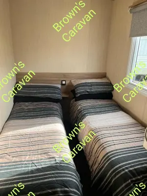 two beds in a room with words on the wall at Browns 137 Snowdon Summit 099 in Barmouth