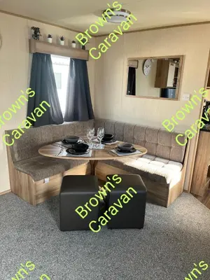 a living room with a couch and a table at Browns 137 Snowdon Summit 099 in Barmouth
