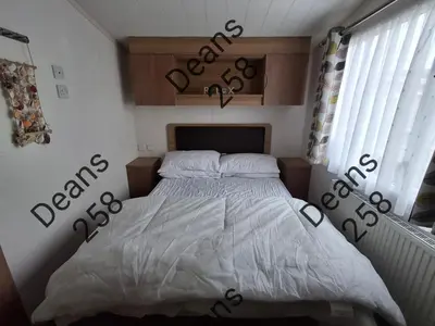 a bedroom with a bed with letters on the wall at Deans Snowdon Summit 109 in Barmouth