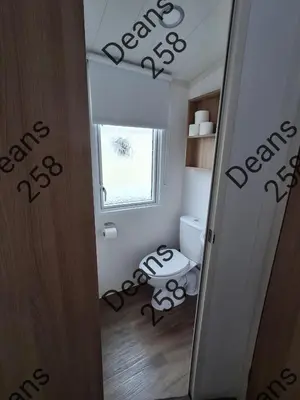 a small bathroom with a toilet and a window at Deans Snowdon Summit 109 in Barmouth