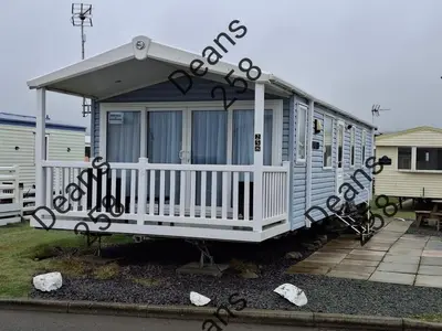 a mobile home with a porch and a white railing at Deans Snowdon Summit 109 in Barmouth