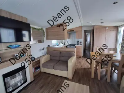 a living room with a couch and a dining room at Deans Snowdon Summit 109 in Barmouth