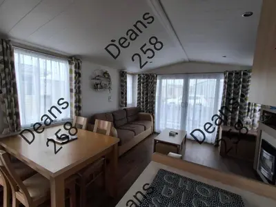 a living room with a couch and a table at Deans Snowdon Summit 109 in Barmouth