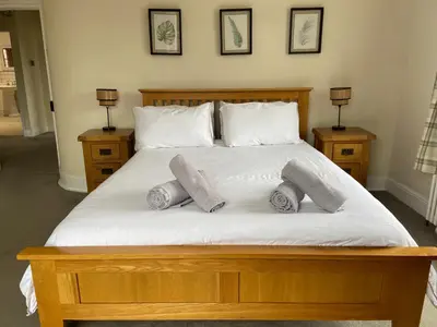 a bed with three pillows on top of it at Town centre Victorian period 3 bedroom home in Bishops Castle