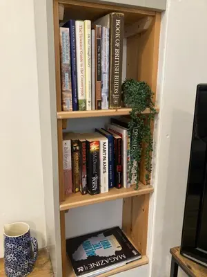 a book shelf filled with books in a room at Ludford View, riverside cottage in Ludlow with private parking in Ludlow