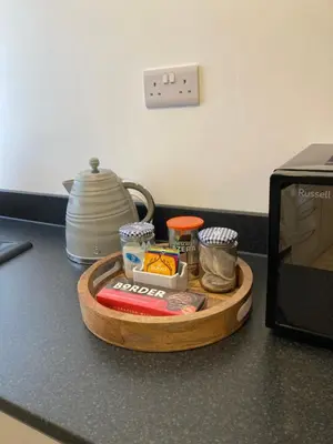 a tray of food on a counter next to a microwave at Ludford View, riverside cottage in Ludlow with private parking in Ludlow