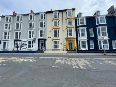 a row of buildings on a city street with a road at Cranwell Court in Aberystwyth