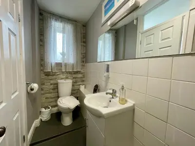 a bathroom with a sink and a toilet and a mirror at Cranwell Court in Aberystwyth