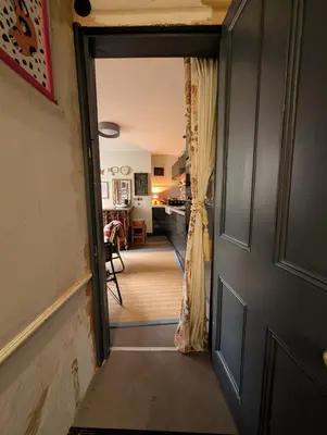 a door leading into a room with a kitchen at Grosvenor Studio Apartment in Llandrindod Wells