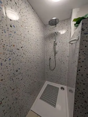 a bathroom with a shower with a walk in shower at Grosvenor Studio Apartment in Llandrindod Wells