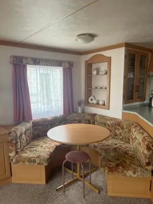 a living room with a couch and a table at Static Caravan in Aberystwyth