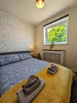 a bedroom with a bed with towels on it at Your Leominster Base - 3BR Home with Garden & Parking in Leominster
