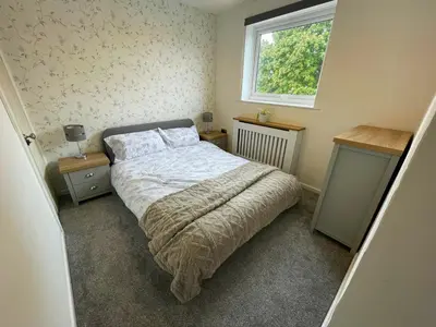 a small bedroom with a bed and a window at Your Leominster Base - 3BR Home with Garden & Parking in Leominster