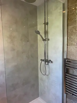 a shower with a glass door in a bathroom at Y Bwthyn in Llanfihangel-geneuʼr-glyn