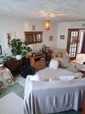 a living room with a bed and a couch at King bed, opposite the beach in Borth