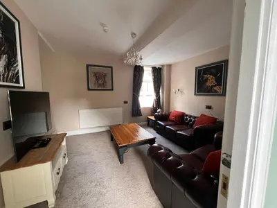 a living room with a couch and a table at Cilgwyn Manor in Myddfai