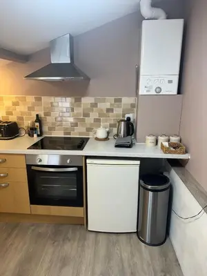a kitchen with a stove and a counter top at Old Post Office in Talgarth