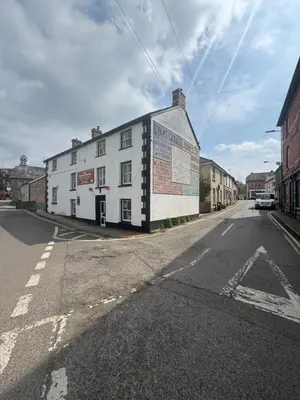 a white building on the side of a street at Old Post Office in Talgarth