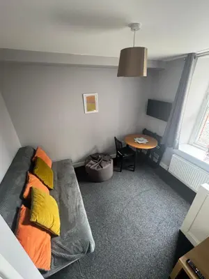 a living room with a couch and a table at Old Post Office in Talgarth