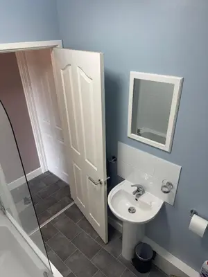 a bathroom with a sink and a mirror at Old Post Office in Talgarth