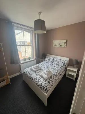 a bedroom with a bed and a window at Old Post Office in Talgarth