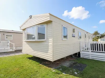 a tiny house sitting on top of a yard at Beachcombers Barmouth Bay Holiday Park in Talybont