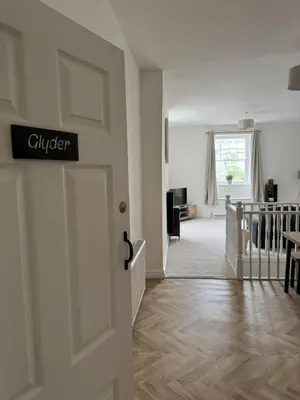 a door with a sign that reads clutter in a living room at Glyder Flat - North Wales in Dolgellau