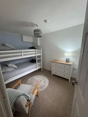 a bedroom with a bunk bed and a night stand at Glyder Flat - North Wales in Dolgellau