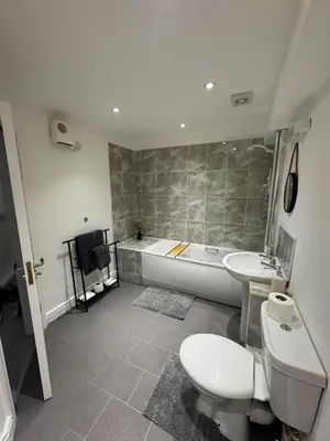 a bathroom with a toilet and a tub and a sink at Glyder Flat - North Wales in Dolgellau