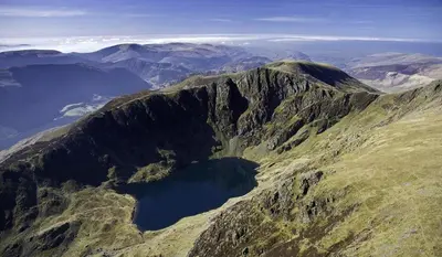an aerial view of a mountain with a lake on it at Glyder Flat - North Wales in Dolgellau