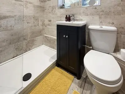 a bathroom with a toilet and a sink and a tub at Tegfryn Cottage in Tanygrisiau